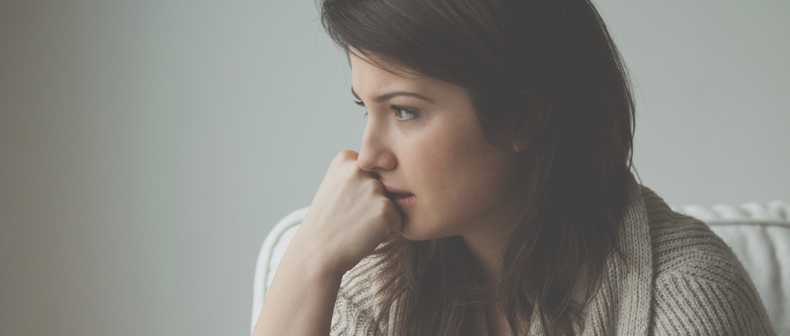 Portrait of melancholy women sitting alone